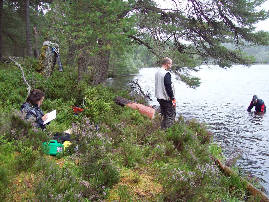 The author (left, taking noties) in the field with the lab.